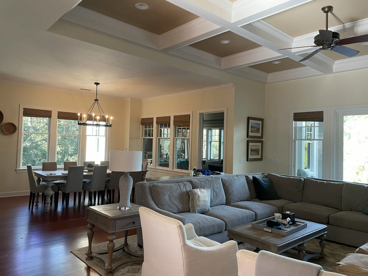 Open living and dining room beneath a coffered ceiling
