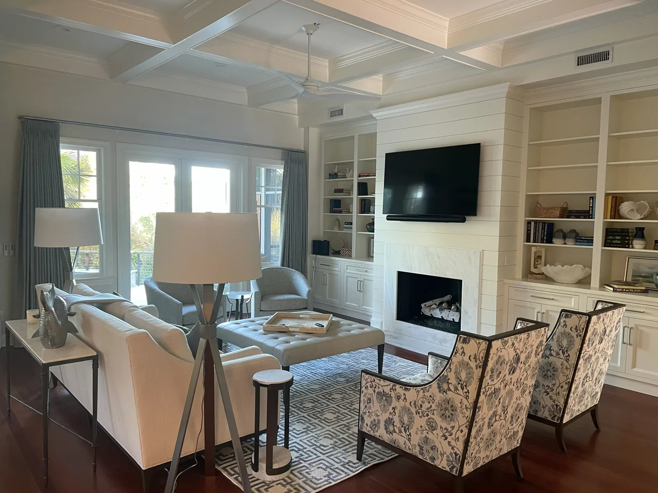 Living area with patterned chairs and built-in cabinets