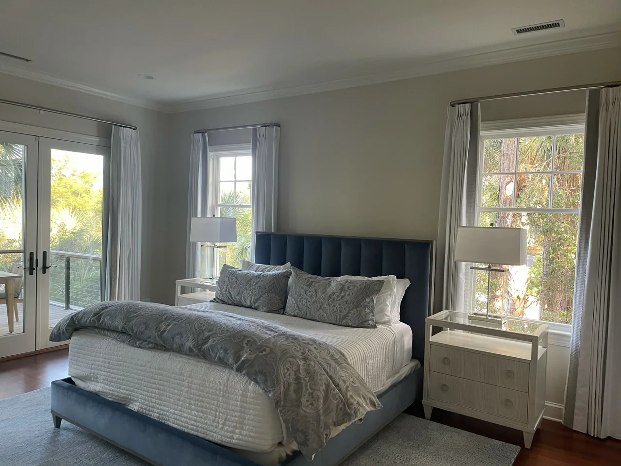 Bedroom with a blue upholstered headboard