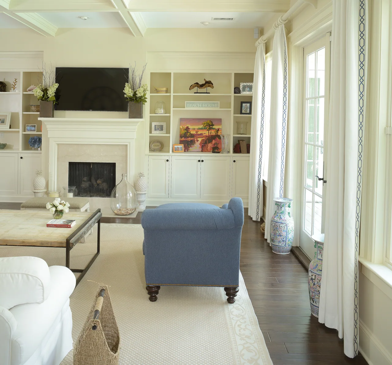 Living room with built-in shelving and a pale blue armchair