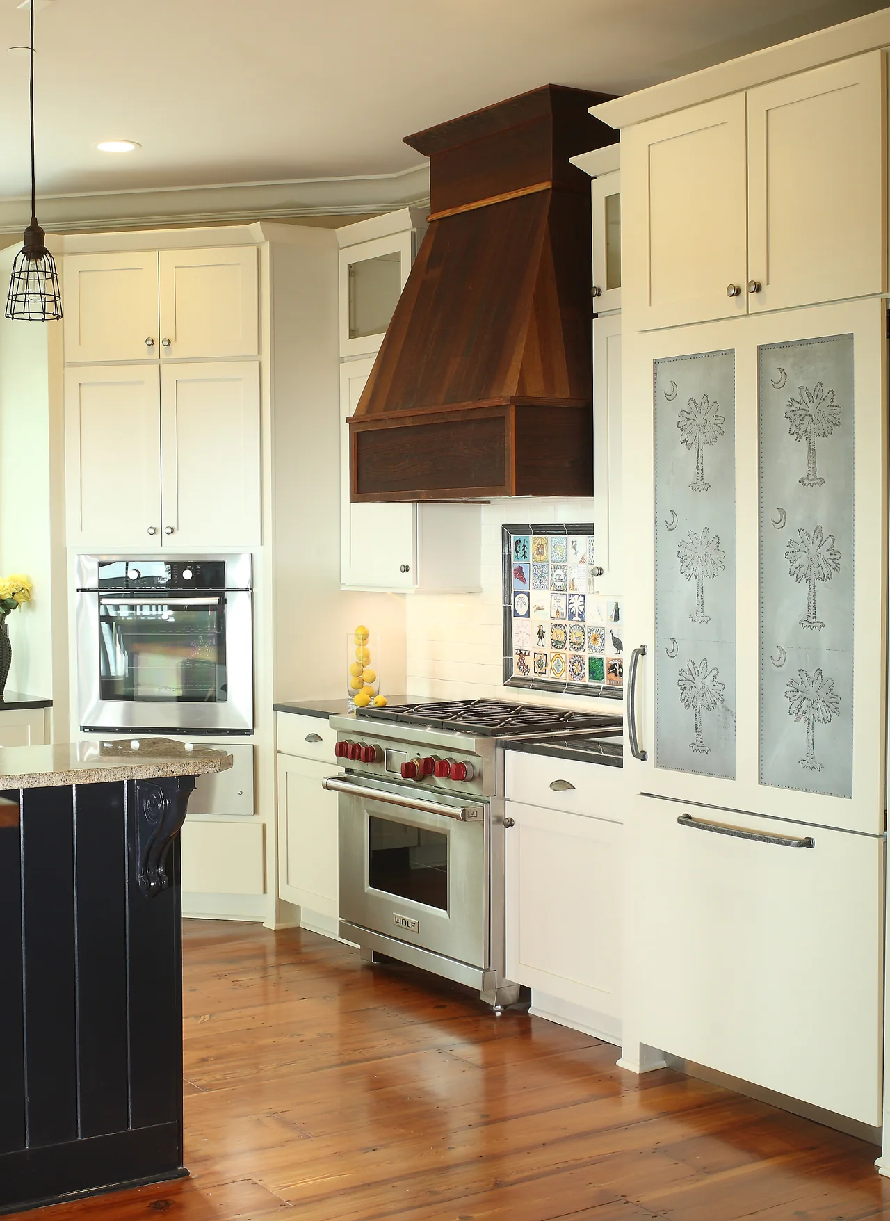 Kitchen with custom cabinetry and a warm wood range hood
