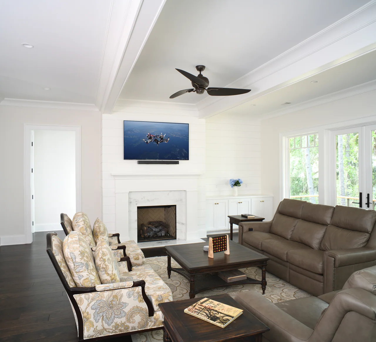 Living room with comfortable seating and a white fireplace