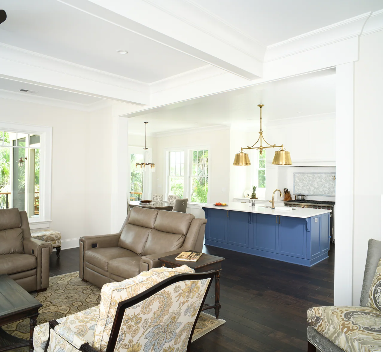 Living area opening to a kitchen with a blue island