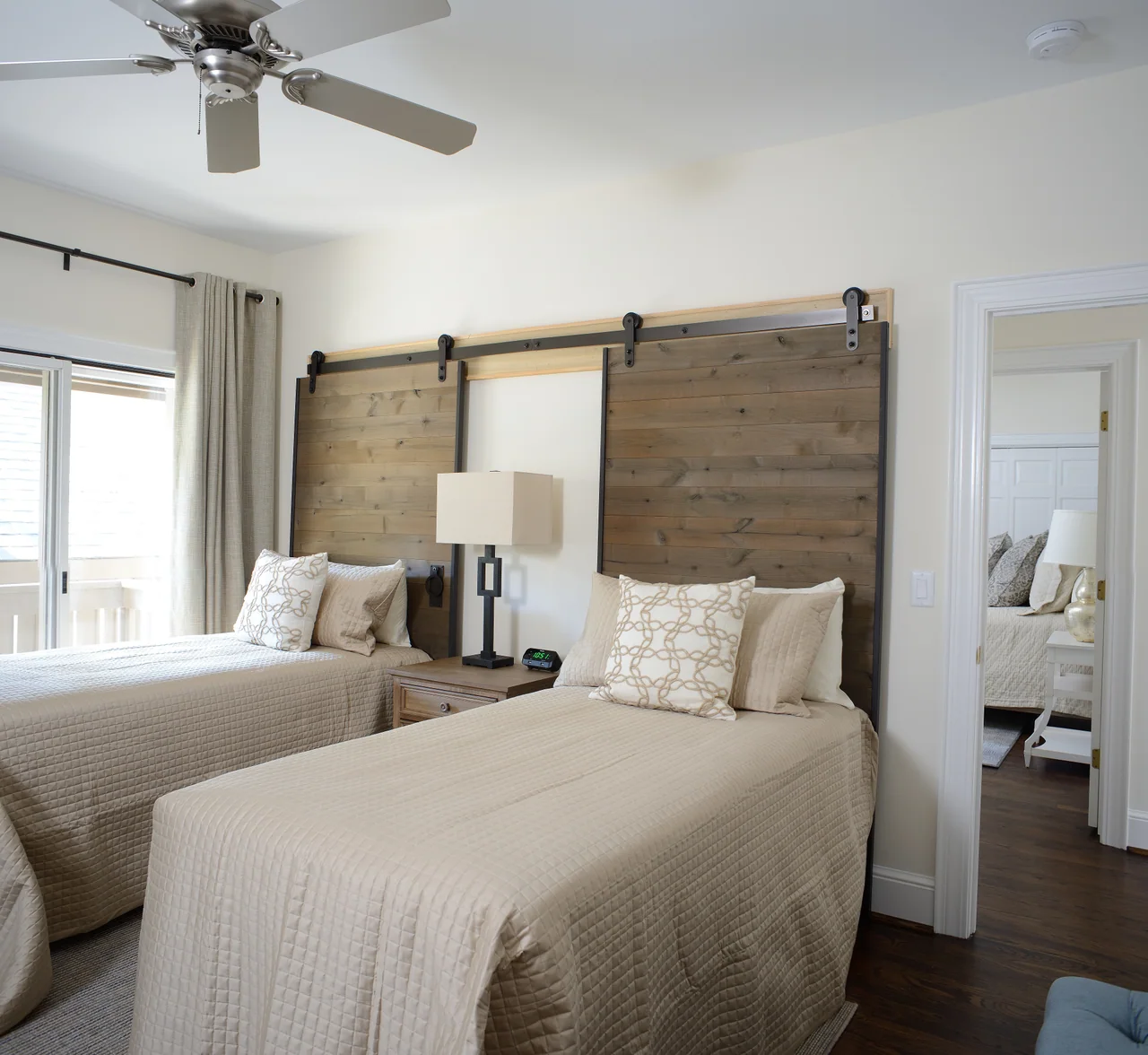 Guest bedroom with twin beds and sliding barn doors