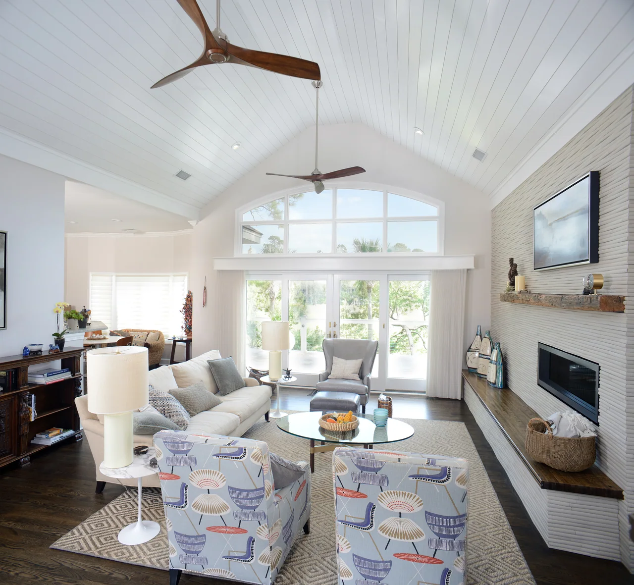 Living room with vaulted ceiling and pale blue patterned seating