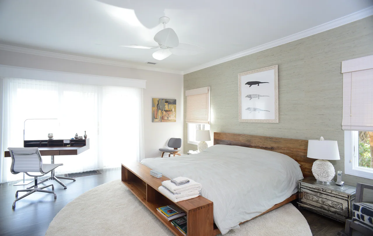 Bedroom with a wood headboard and upholstered seating